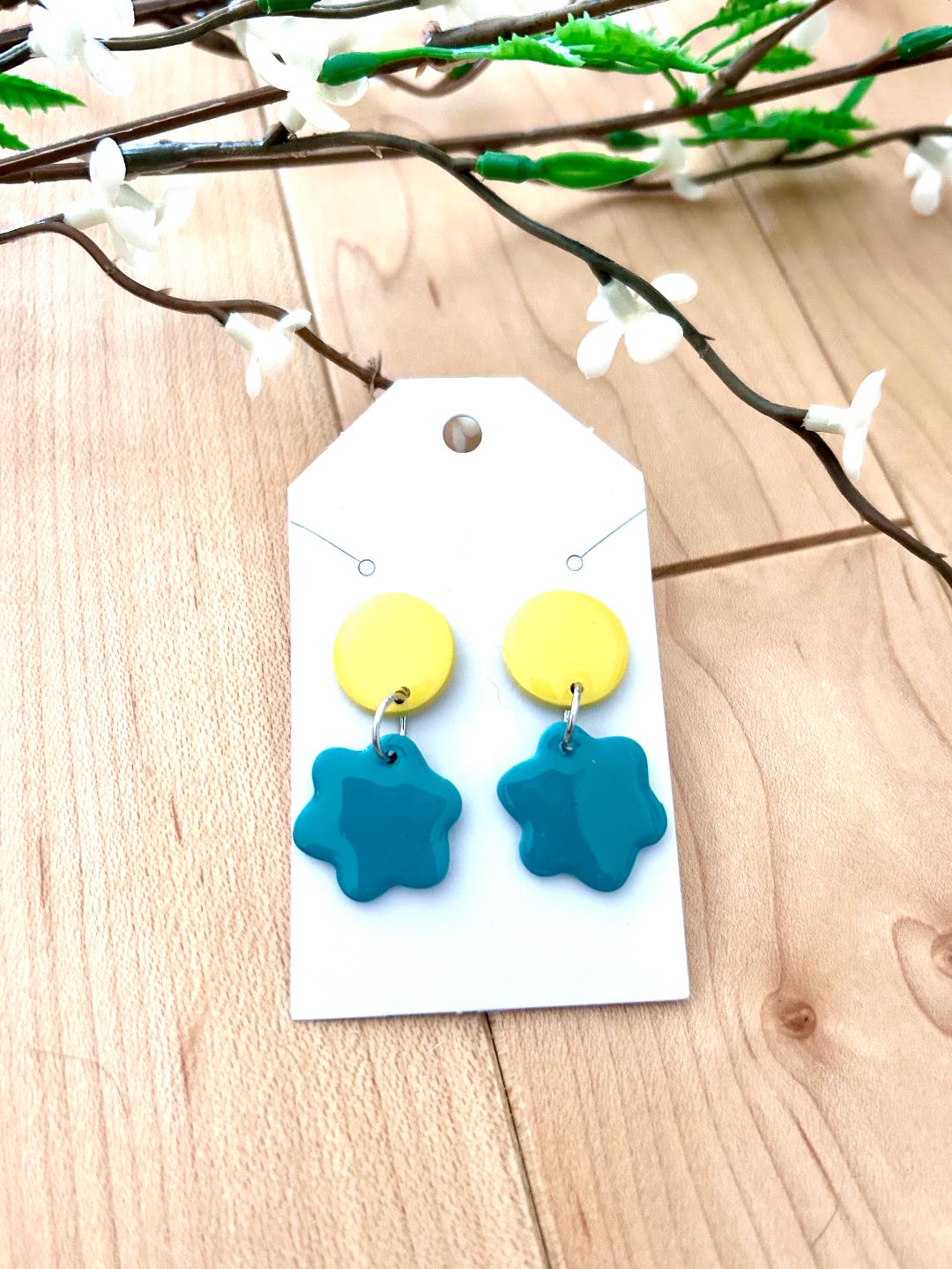Small flower dangle earrings on a dot