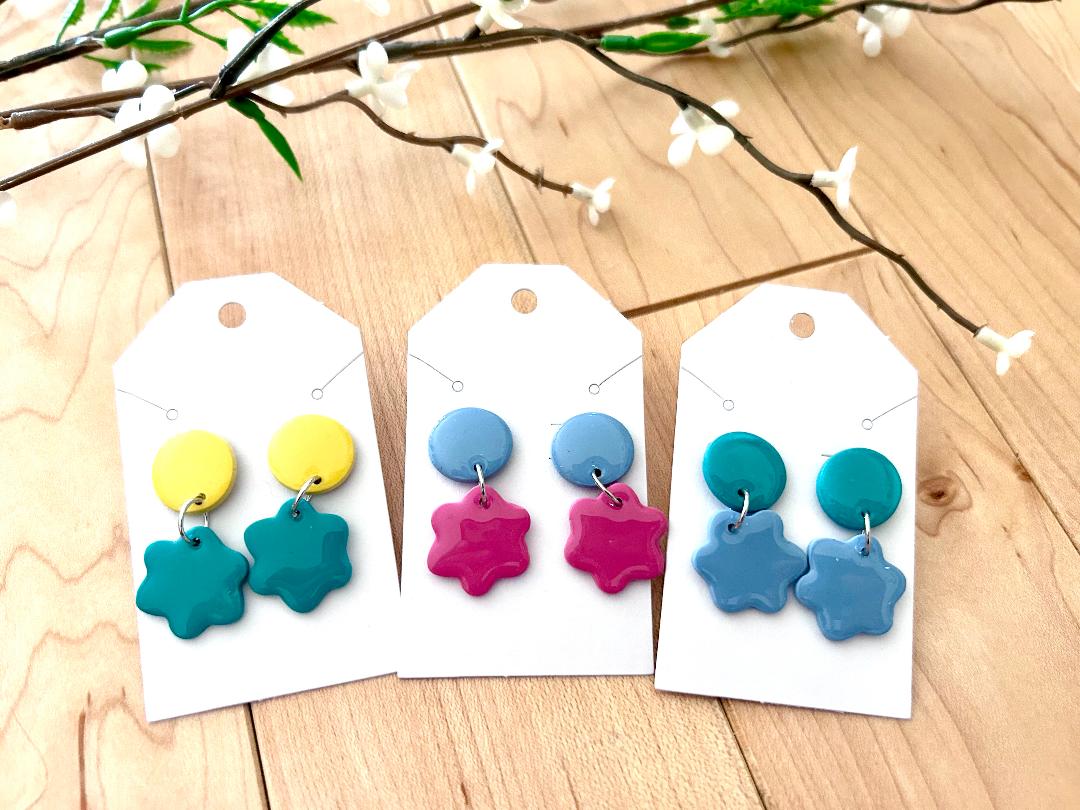 Small flower dangle earrings on a dot