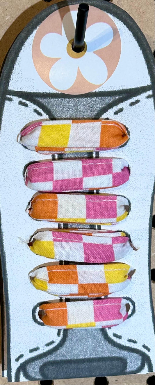 orange, yellow, white, and pink fabric shoelaces
